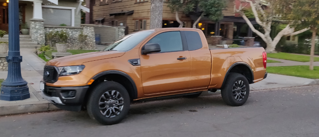new ford ranger in orange parked on street