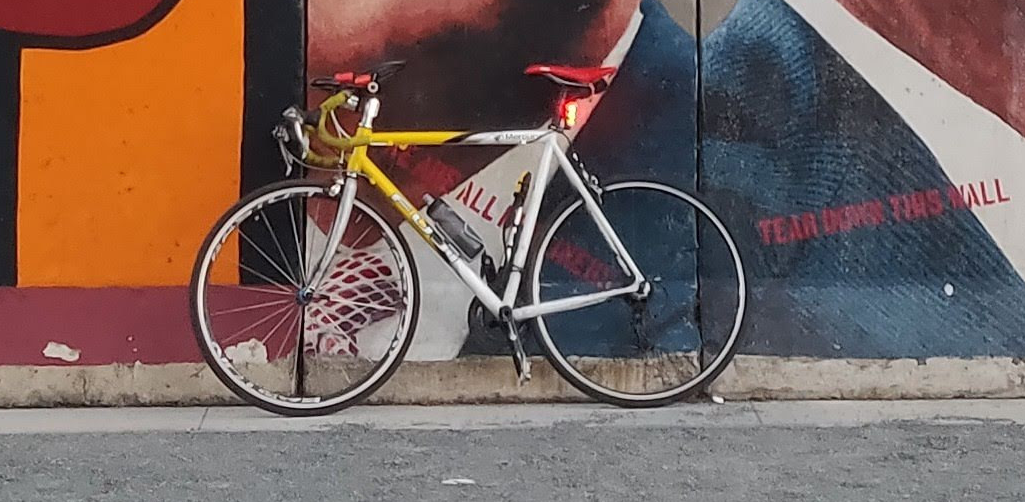 road bicycle in front of mural