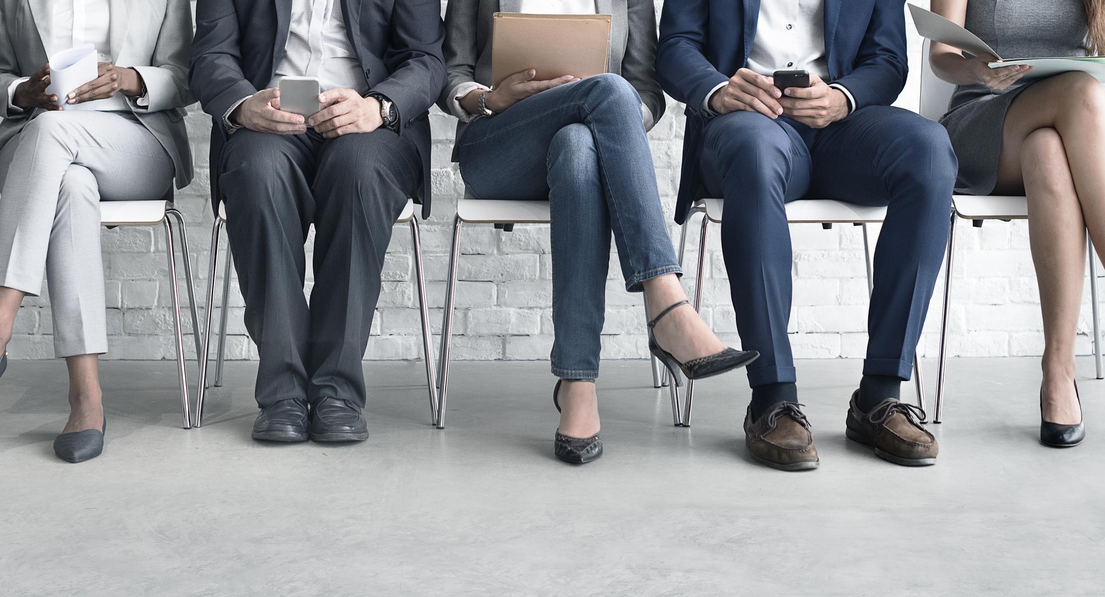 people sitting in chairs waiting for interviews