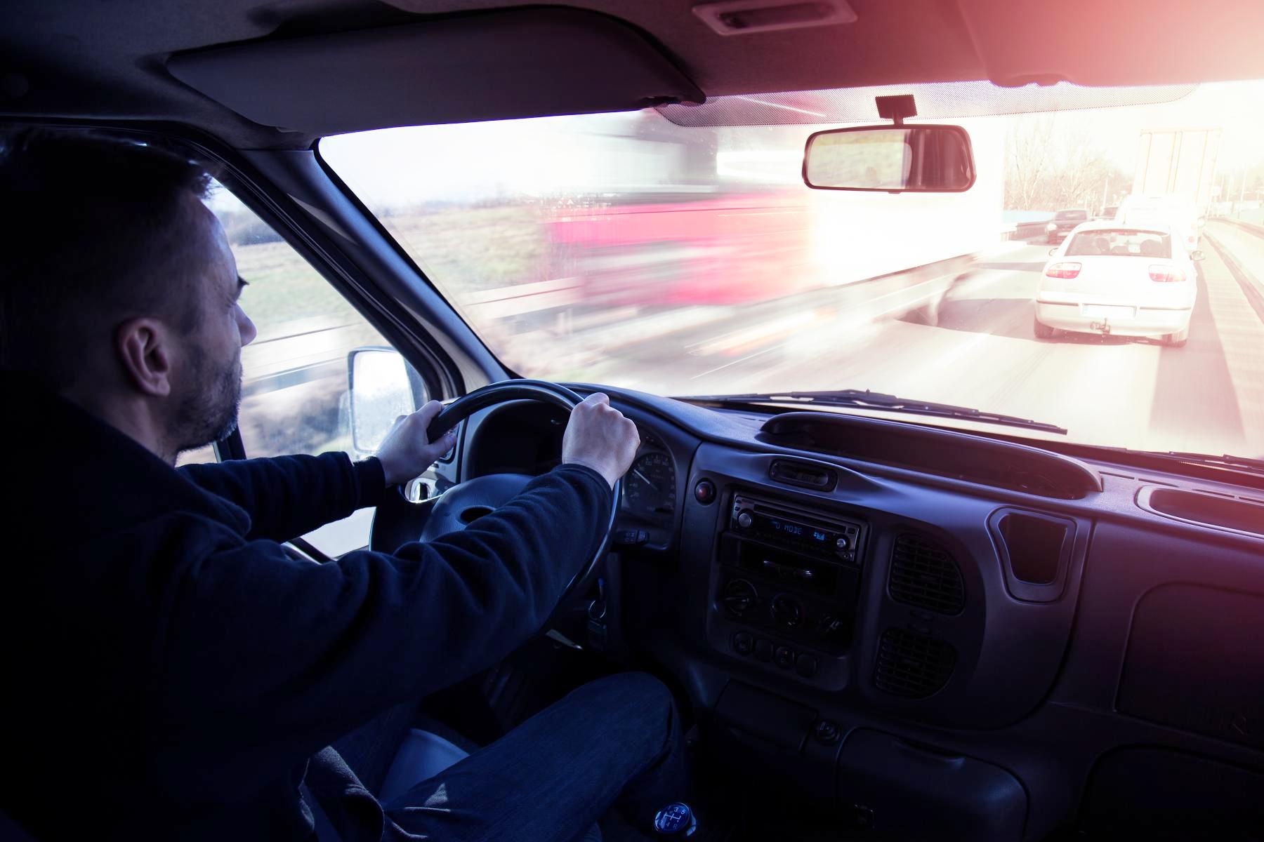 man driving a van in traffic