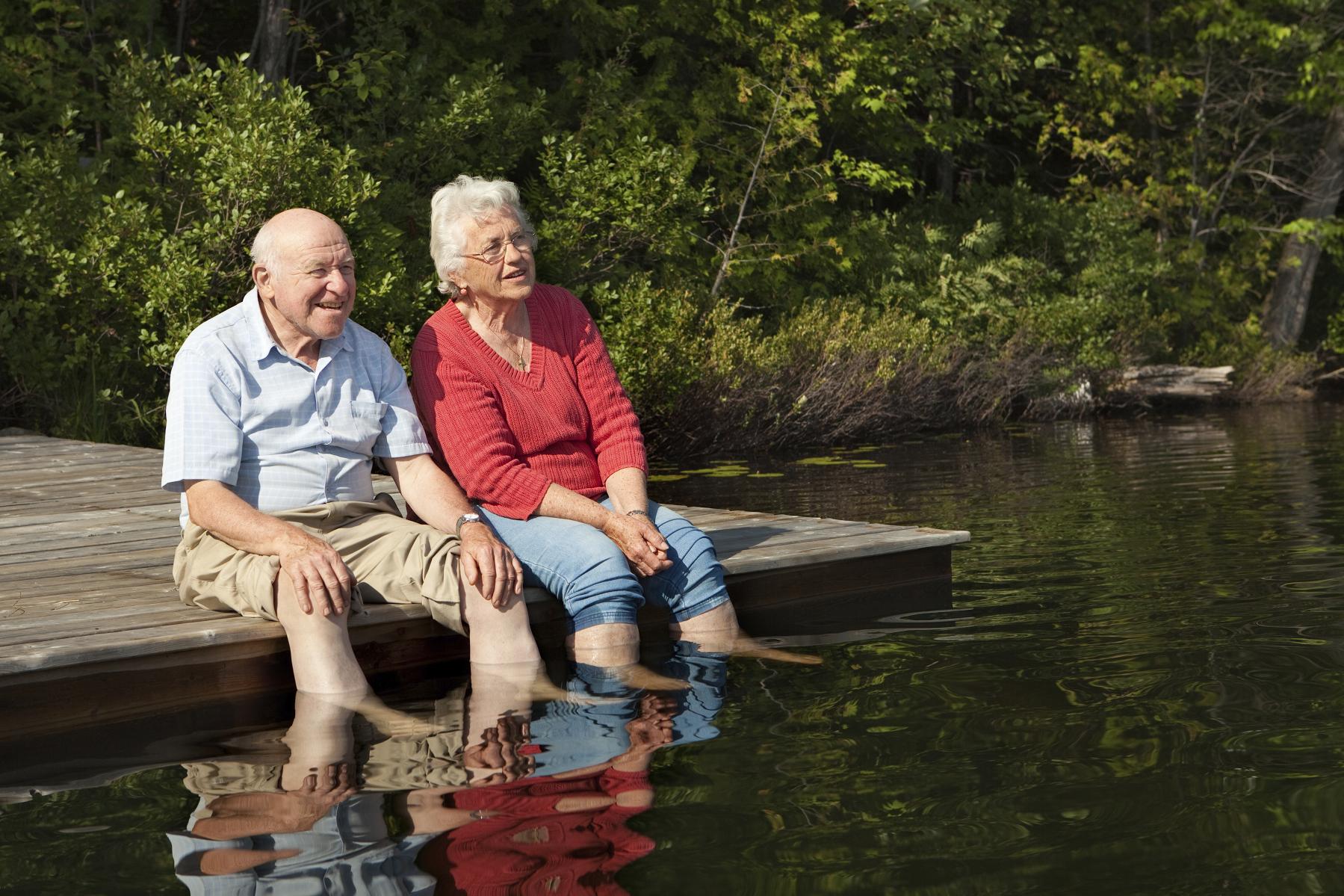 elderly people dipping feet in the water