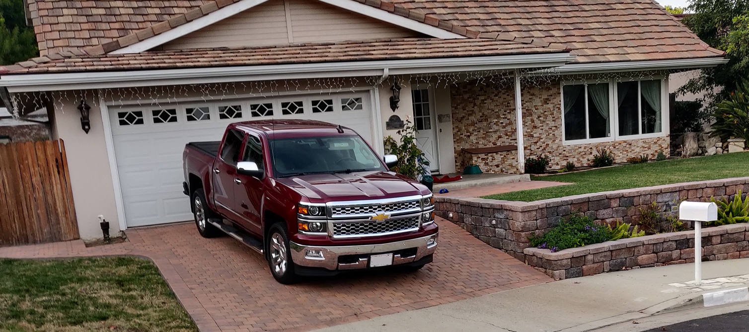 maroon american truck in front of house