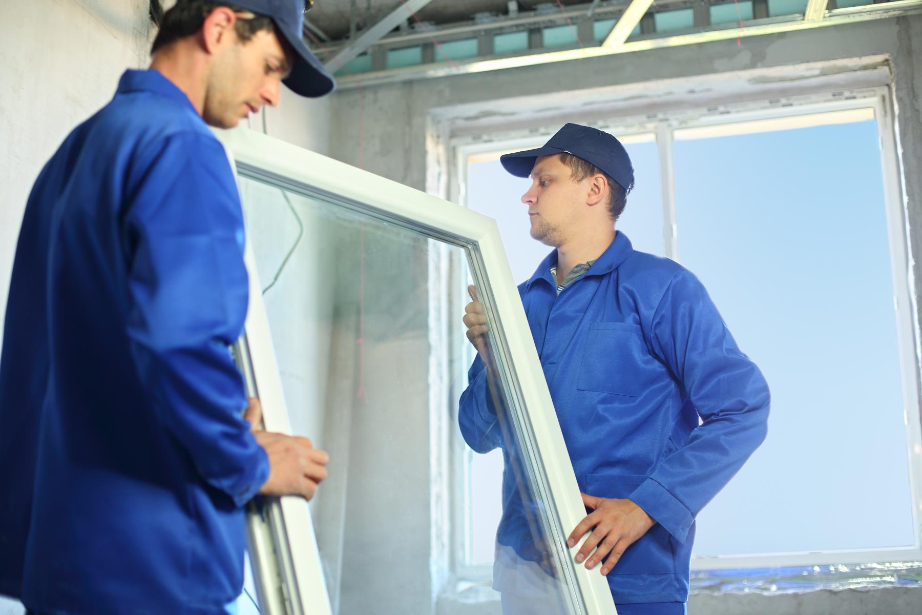 men carrying new window to install