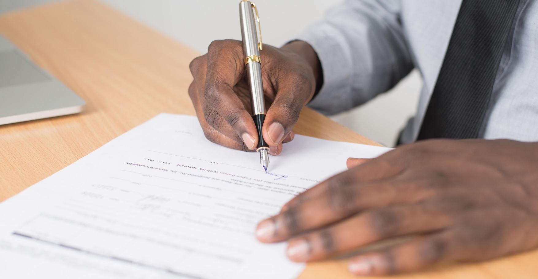 man signing loan papers