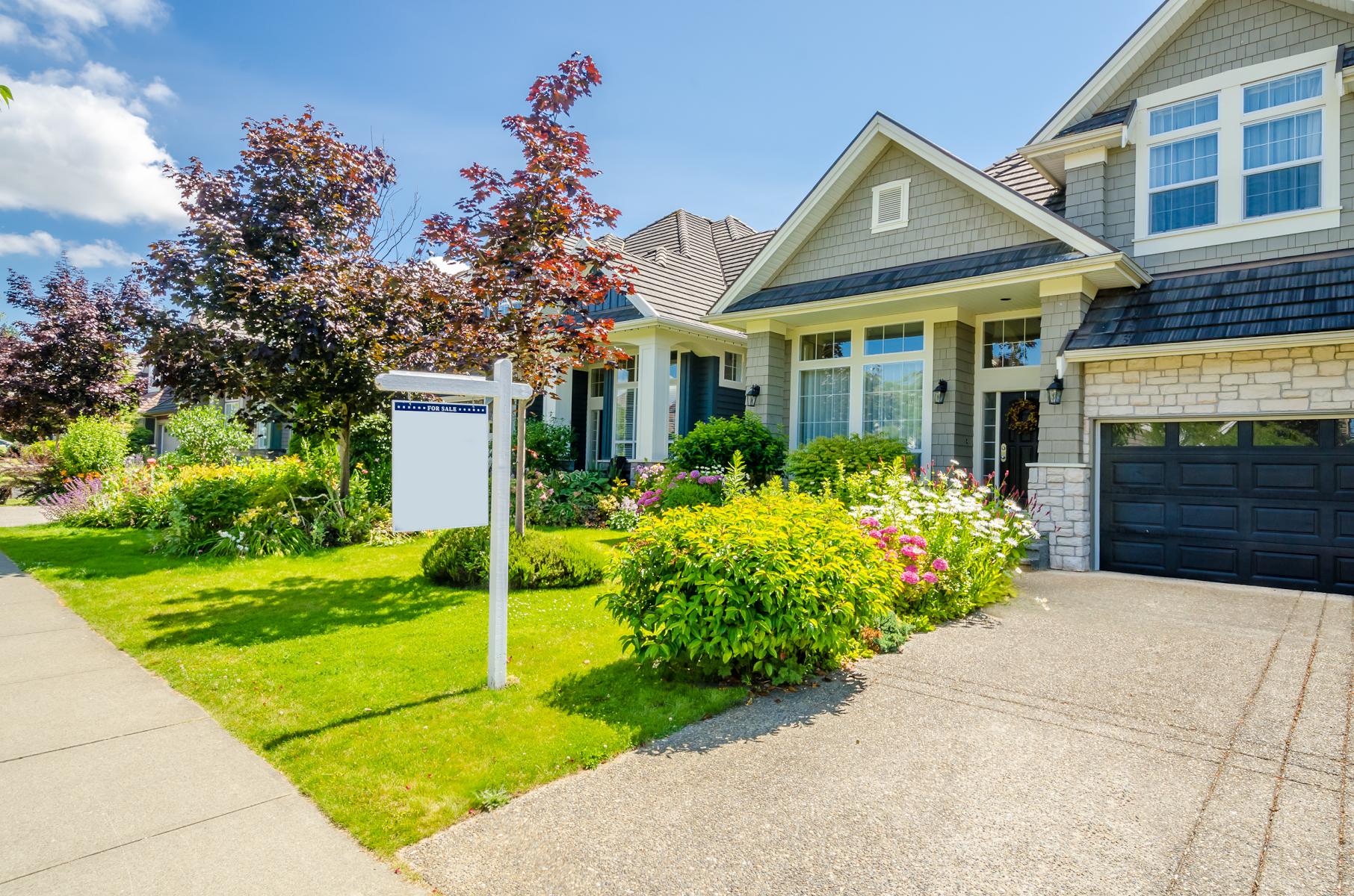 house for sale with sign in front
